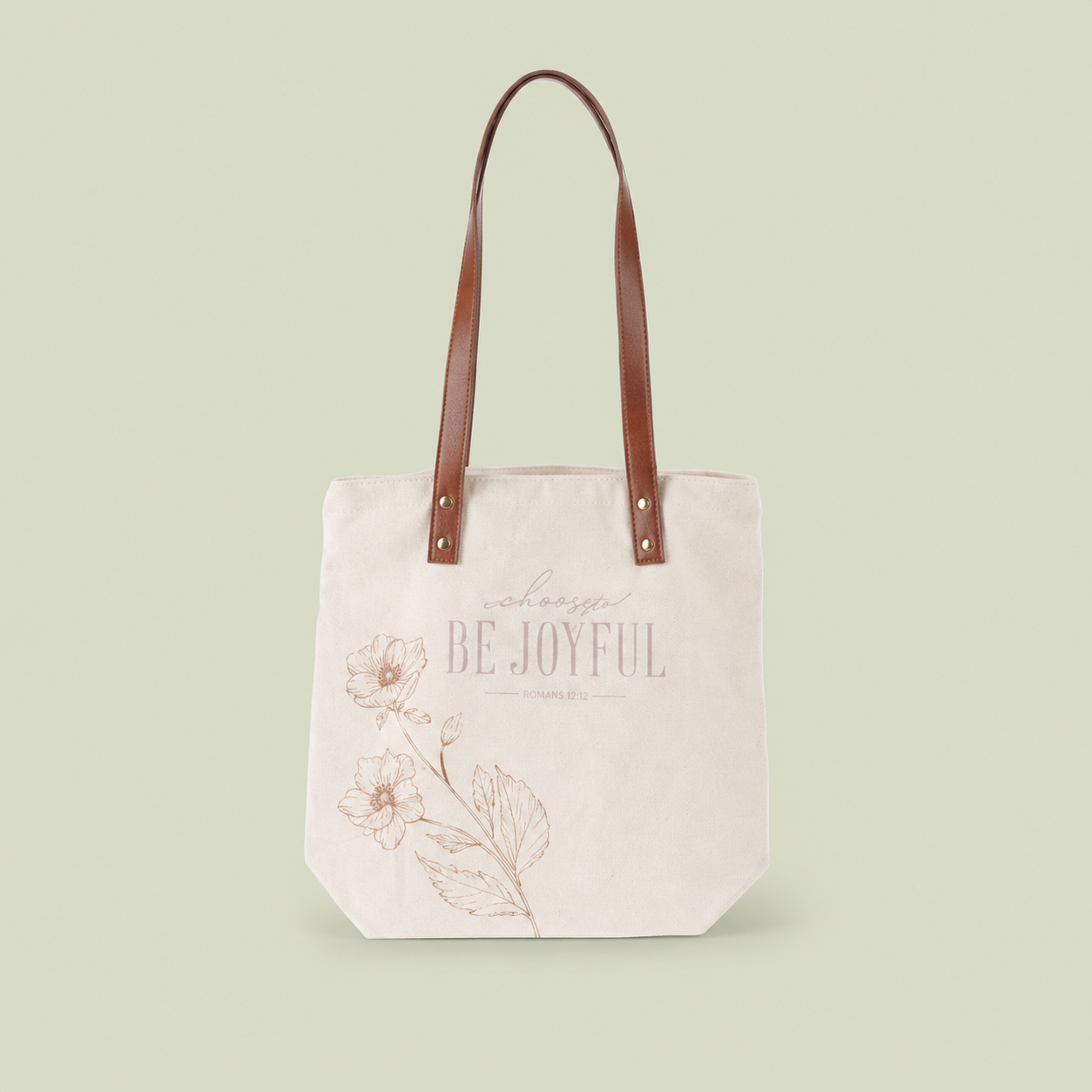 Be Joyful canvas tote bag on a soft sage background