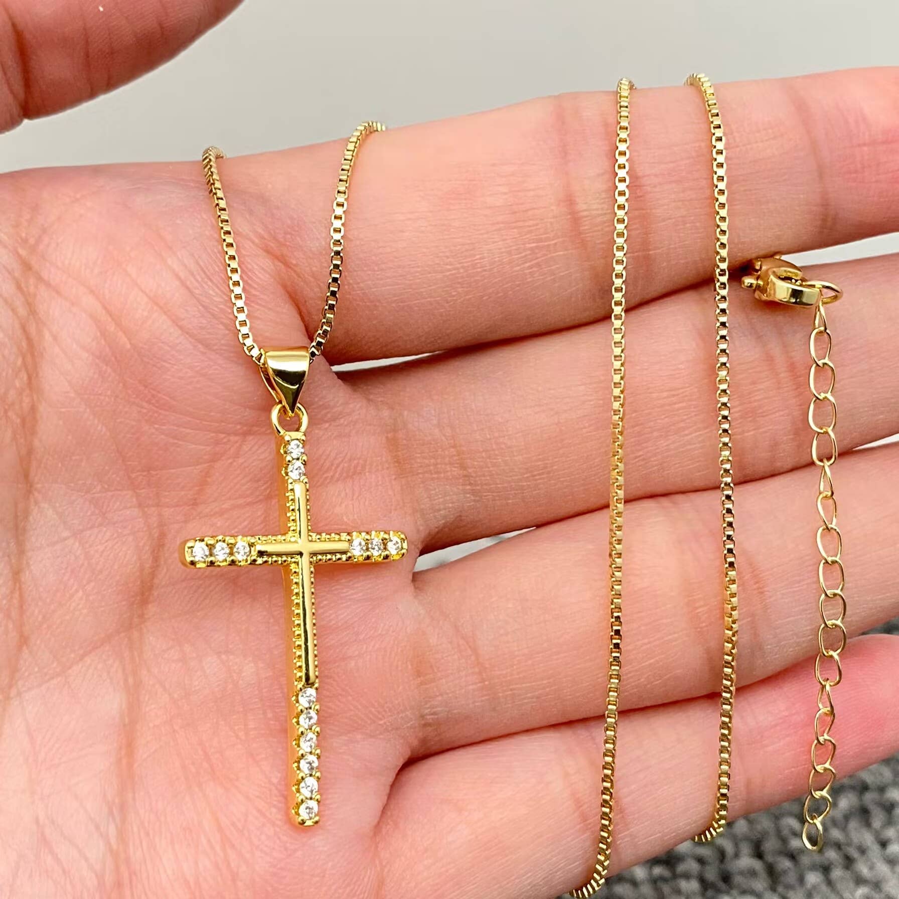 Front of the cubic zirconia 14K gold plated cross charm necklace